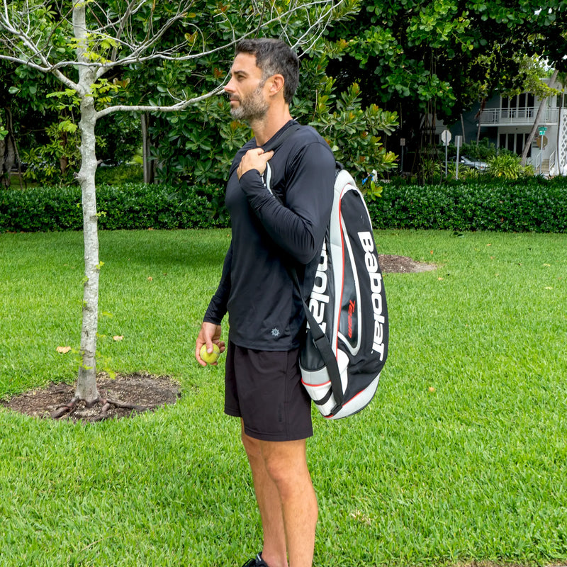 Athlete with sports gear wearing black Belesun sun shirt at the park