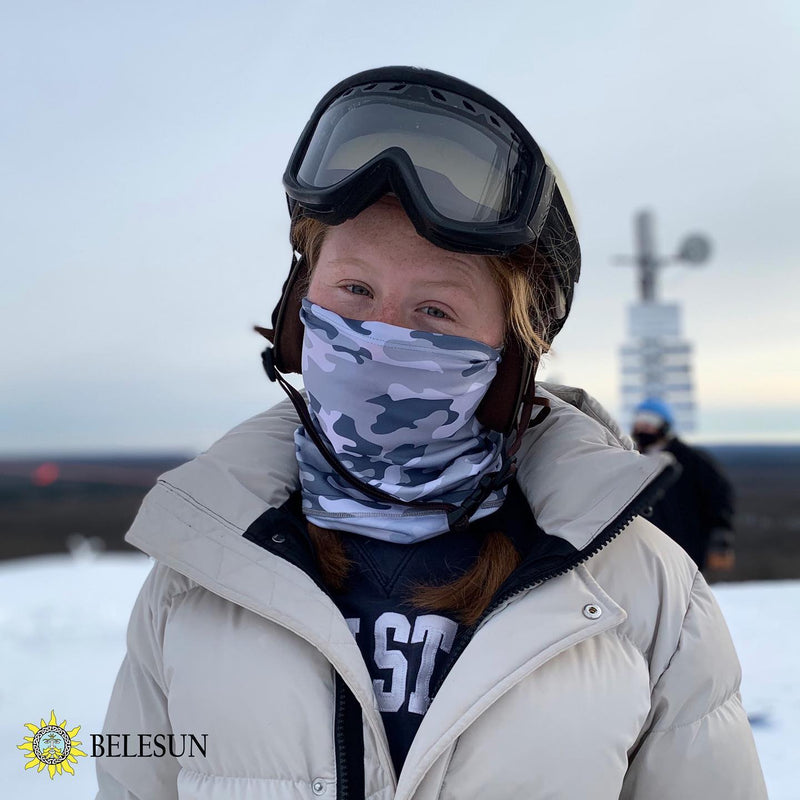Woman wearing ski gear with neck gaiter for sun and wind protection